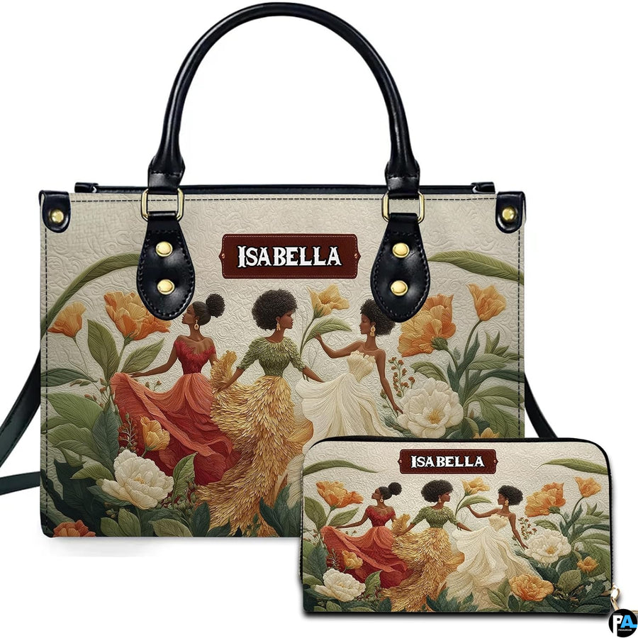 Front view of structured handbag and matching wallet showcasing three women dancing in floral petal gowns.
