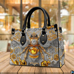 Top down view of bee handbag showing zipper closure and interior opening.