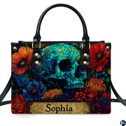 Stained glass mosaic skull handbag displayed alone on white studio background.