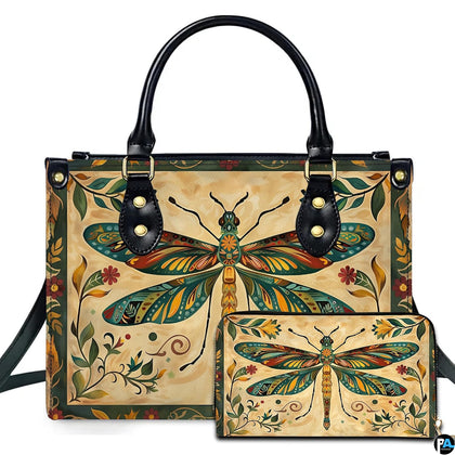 Studio display of vintage folk art dragonfly handbag and matching wallet with botanical border on parchment
