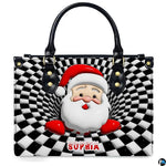 Front view of holiday handbag featuring optical illusion vortex Santa with snow-dusted lettering.