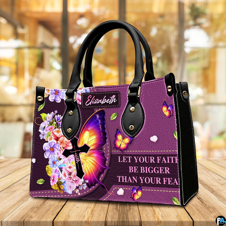 Purple floral butterfly cross handbag sitting on a wooden tabletop in a bright interior cafe