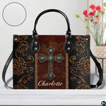 Side profile view of structured western turquoise cross handbag.