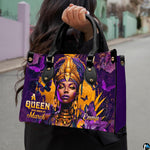 Close-up front view of African queen portrait with golden crown on structured tote handbag