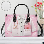 Bottom view of pink doctor handbag showing flat rectangular base