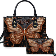 Handbag and matching wallet set featuring a sculpted bronze butterfly on dark carved ground.