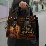Model carrying regal African woman handbag with natural curls