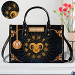 Angled perspective view of zodiac ram handbag highlighting radiating gold rays and corner filigree.