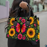 Outdoor street view showing pink butterfly and sunflower artwork held by pedestrian along city sidewalk.