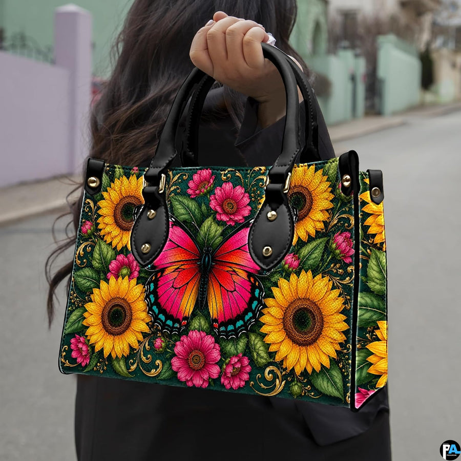Outdoor street view showing pink butterfly and sunflower artwork held by pedestrian along city sidewalk.