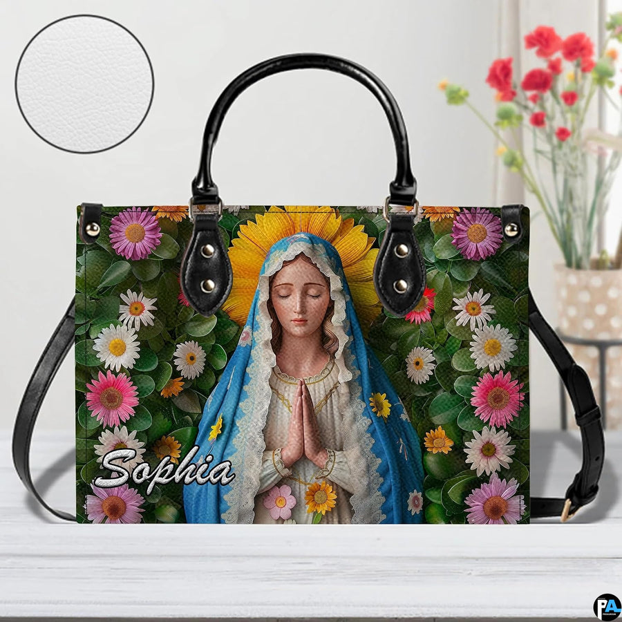 Detailed front view of Virgin Mary sunflower halo handbag with texture sample inset