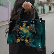 Front angled view displaying the ornate golden turtle illustration against deep emerald watercolor.
