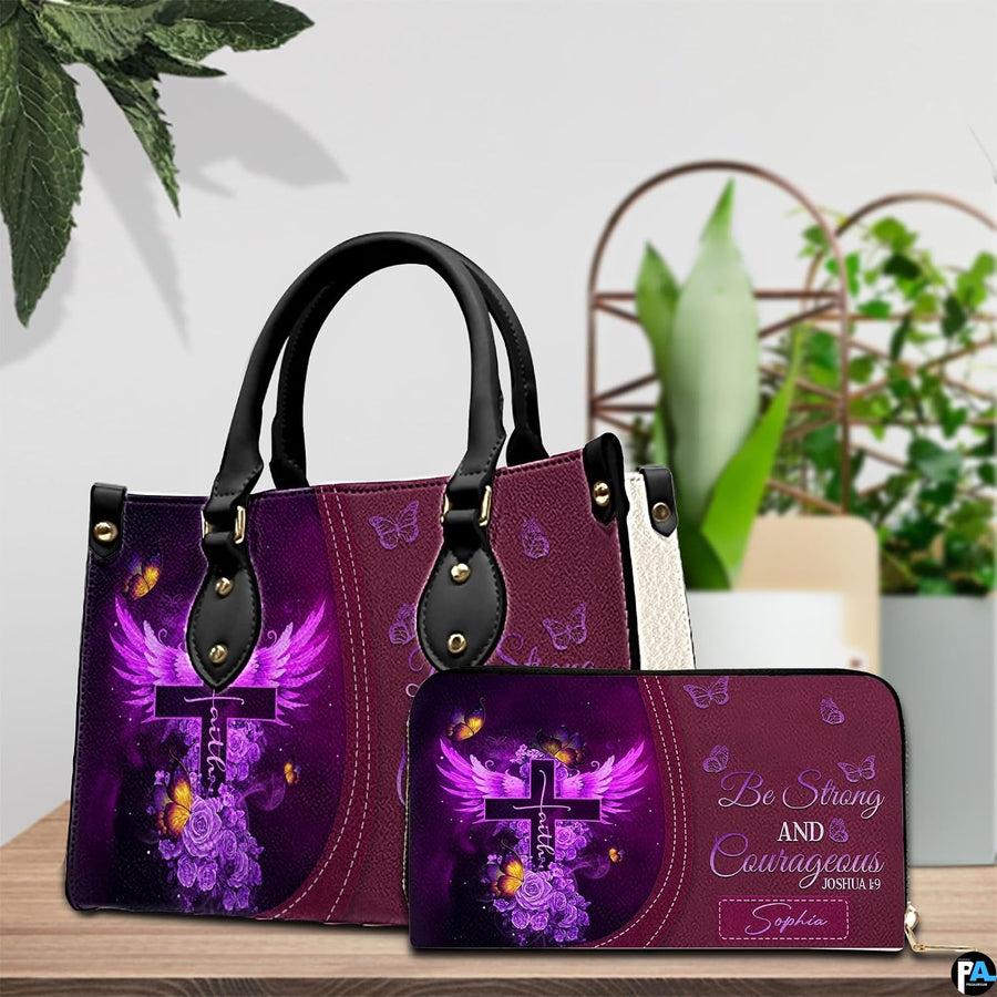 Purple winged cross handbag and matching wallet displayed on a wooden surface beside green foliage.