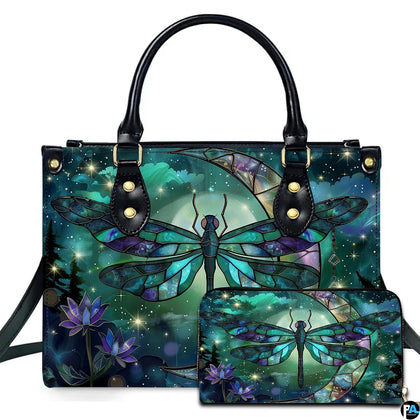 Studio display of stained glass dragonfly handbag and matching wallet with crescent moon and blooming lotus