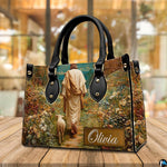 Side perspective view of Good Shepherd wildflower garden handbag and wallet pair