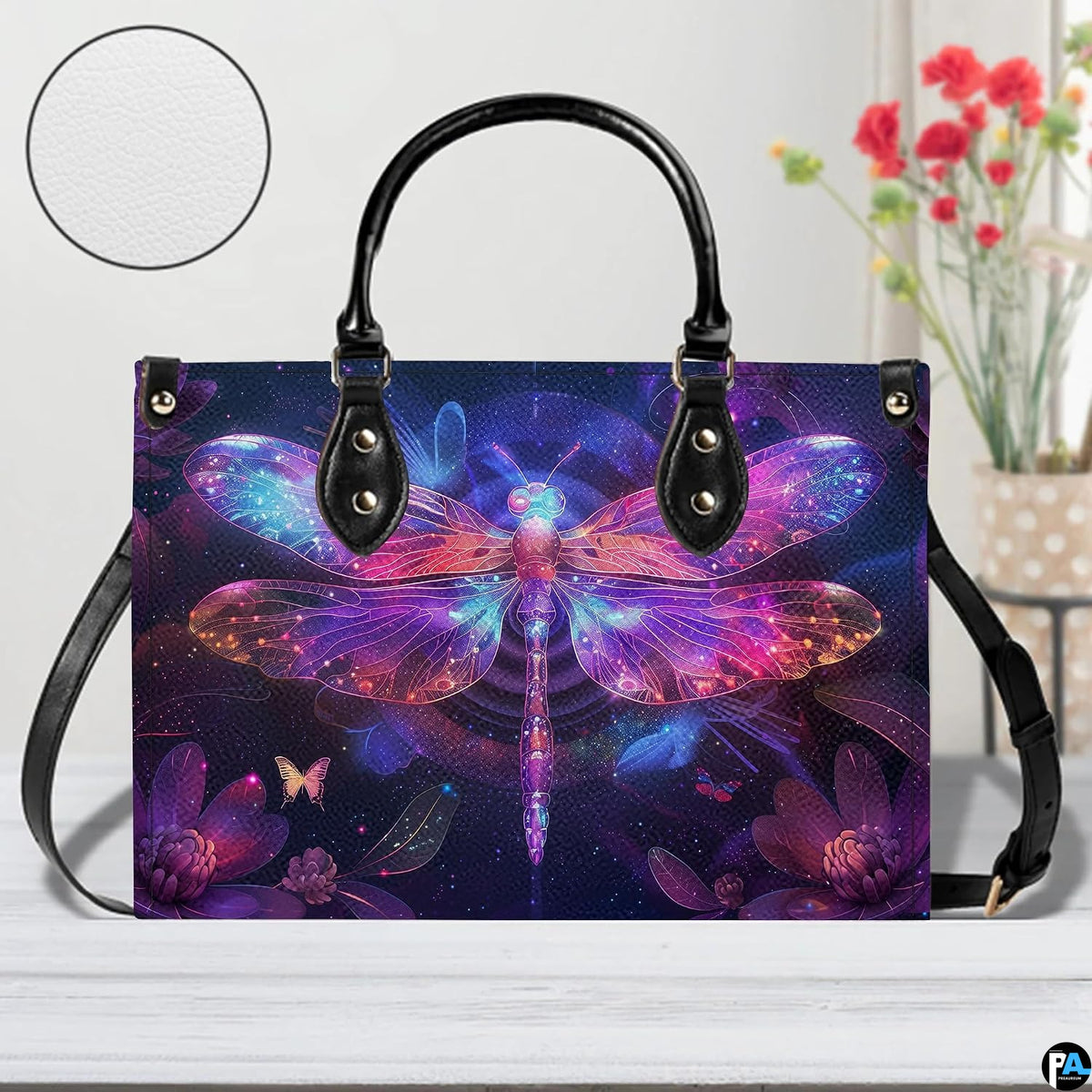 Bottom view of neon dragonfly handbag showing protective metal feet and structured base wrap