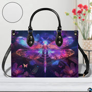 Bottom view of neon dragonfly handbag showing protective metal feet and structured base wrap