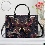 Close-up front view of matching zippered wallet showing gold butterfly