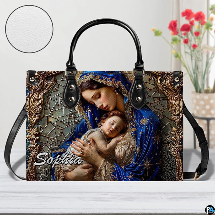 Madonna and sleeping infant motif accessory resting on table with circular texture graphic.