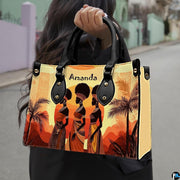 African landscape art prints presentation shown outdoors on a sunlit city pavement walkway.