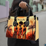 African landscape art prints presentation shown outdoors on a sunlit city pavement walkway.