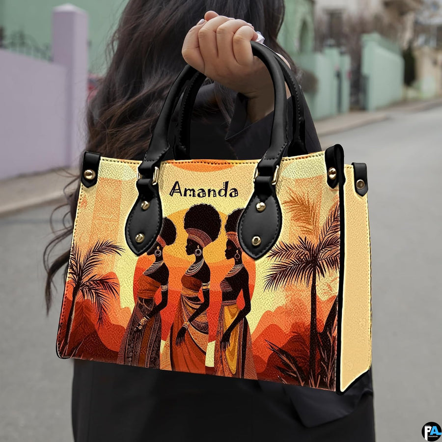 African landscape art prints presentation shown outdoors on a sunlit city pavement walkway.