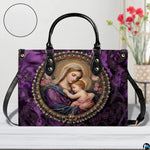 Handbag staged on a light wooden table beside floral decor showing rich purple damask background.