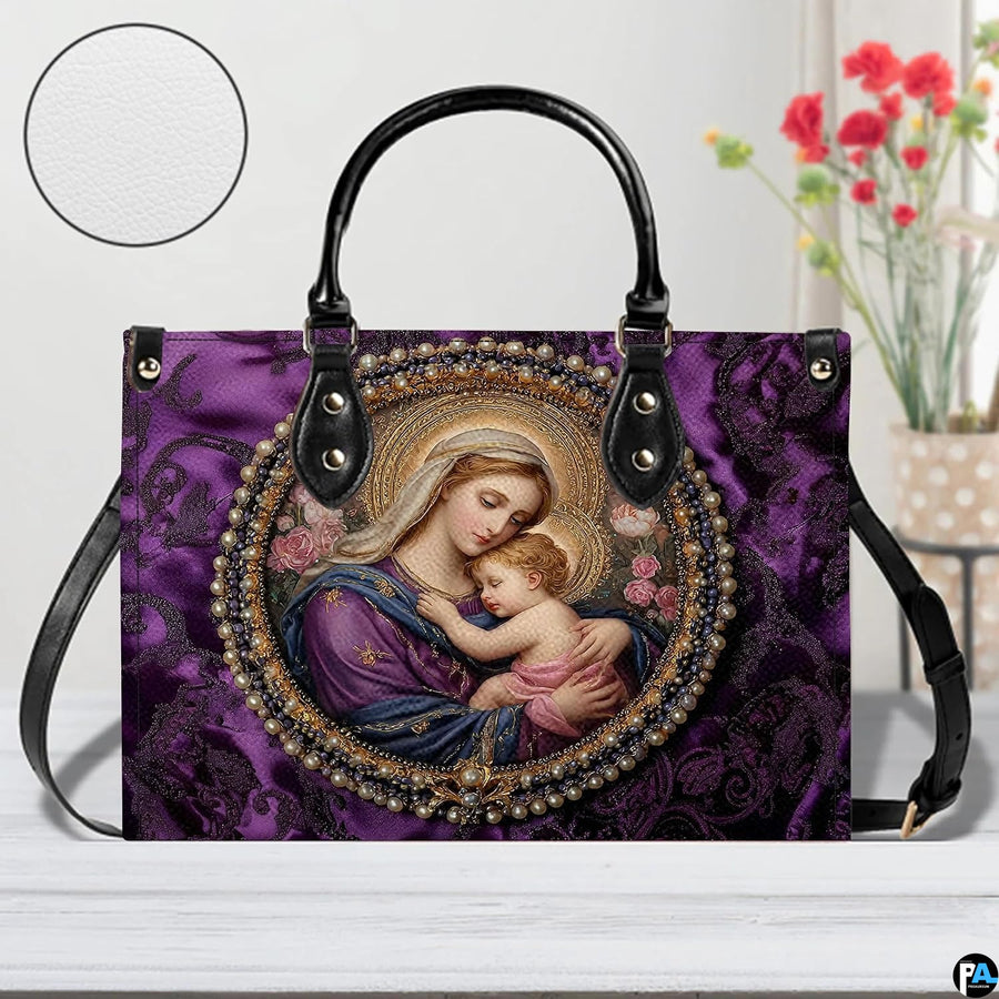 Handbag staged on a light wooden table beside floral decor showing rich purple damask background.