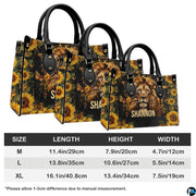 Angled perspective view of lion cross handbag highlighting lion mane details and sunflower borders.