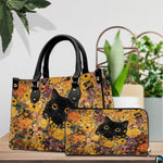 Tabletop scene presenting peeking black cat botanical artwork resting on wood beside green houseplants.