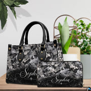 Gothic skull handbag on white table beside floral bouquet with texture swatch inset.