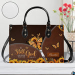Side perspective view of yellow butterfly purse highlighting structured silhouette and carry handles.