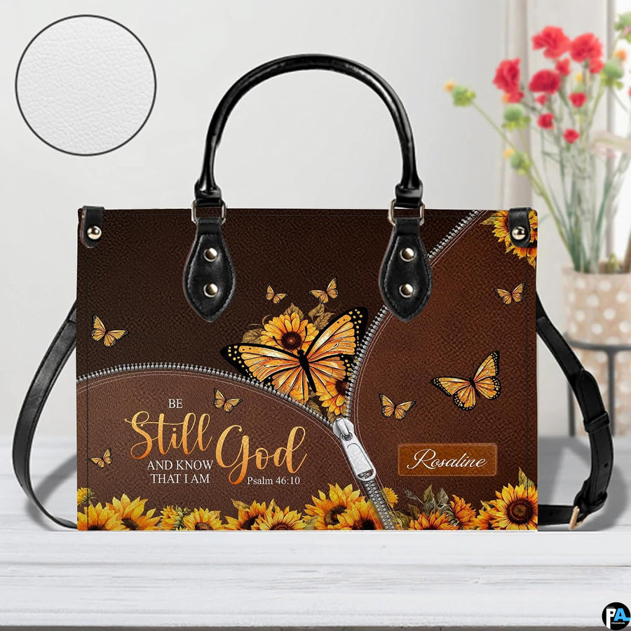 Side perspective view of yellow butterfly purse highlighting structured silhouette and carry handles.