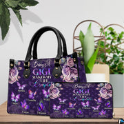 Side profile view of structured purple handbag showing sleek silhouette and black carrying handles.