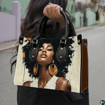 Woman carrying cream and black afro portrait handbag with oversized gold earrings