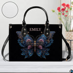Home lifestyle view of floral butterfly handbag on white table beside decorative flowers