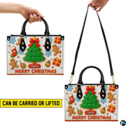 Model carrying the gingerbread holiday handbag by top handles.