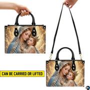 Lifestyle display of crowned Madonna handbag carried by model showing artwork and scale