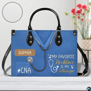 Angled perspective showing blue scrub uniform artwork on structured handbag