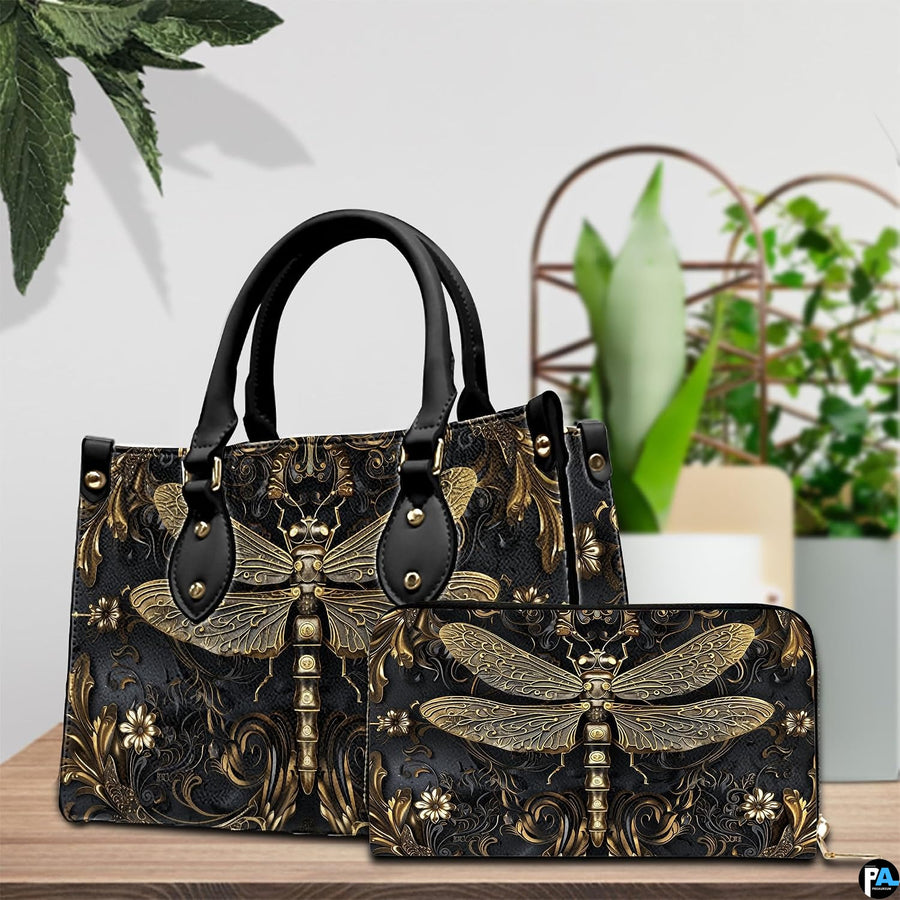 Tabletop lifestyle presentation of gold dragonfly handbag and matching wallet with potted plants