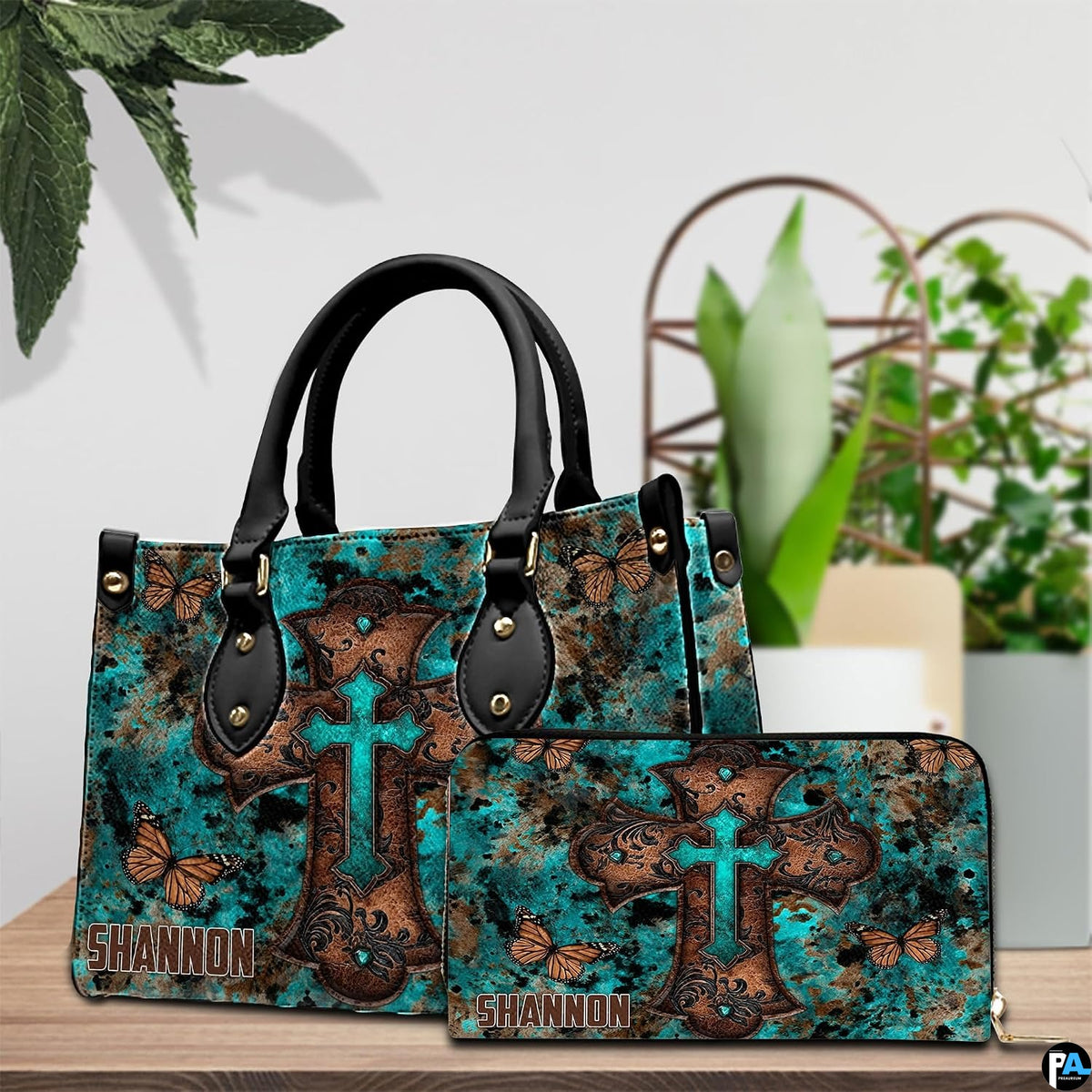 Detailed view of turquoise cross butterfly handbag showing sculpted scroll relief on the cross.
