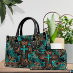 Detailed view of turquoise cross butterfly handbag showing sculpted scroll relief on the cross.