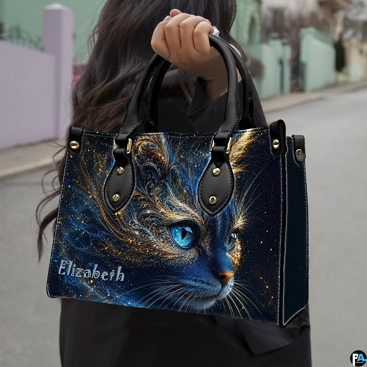 Outdoor perspective showing cosmic blue cat artwork held over arm by pedestrian along city sidewalk.