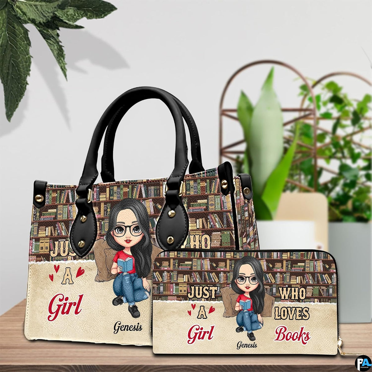 Bookshelf themed handbag and matching wallet styled together on a wooden table beside green plants.