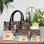 Bookshelf themed handbag and matching wallet styled together on a wooden table beside green plants.
