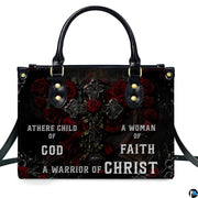 Angled perspective view of gothic cross handbag highlighting rose petals and filigree artwork.