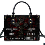 Angled perspective view of gothic cross handbag highlighting rose petals and filigree artwork.