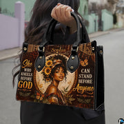 Model carrying sunflower butterfly handbag with geometric artwork