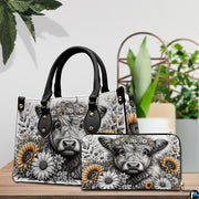 Tabletop presentation of monochrome cow and golden sunflower graphic design on wooden surface