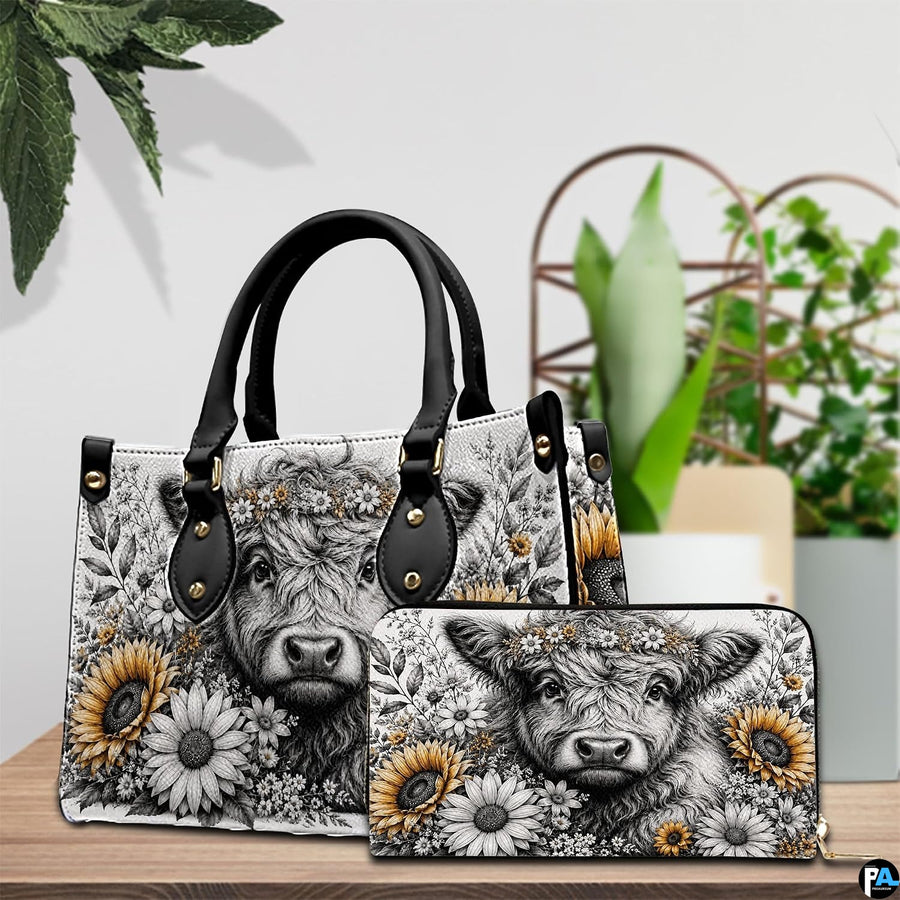Tabletop presentation of monochrome cow and golden sunflower graphic design on wooden surface
